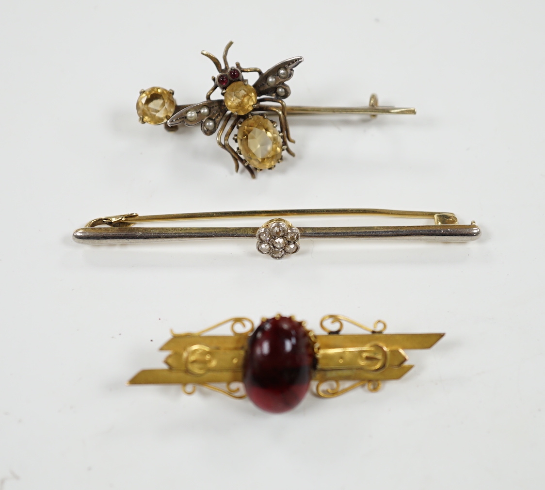 An Edwardian 15ct and diamond cluster set bar brooch, 60mm and two other gem set bar brooches including a bug brooch.